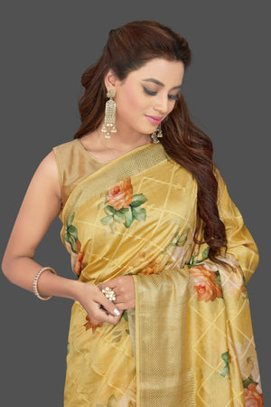 Buy beautiful yellow floral print muga silk saree online in USA with zari border. Make you presence felt with your Indian style on special occasions in beautiful designer sarees, handwoven sarees, muga sarees, tussar silk sarees from Pure Elegance Indian fashion store in USA.-closeup