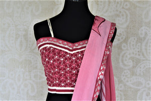 Shop lovely pink leaf print chiffon saree online in USA with strappy blouse. Be the center of attraction at parties and weddings with beautiful georgette sarees, embroidered sarees, printed sarees, Banarasi saris from Pure Elegance Indian fashion store in USA.-blouse pallu