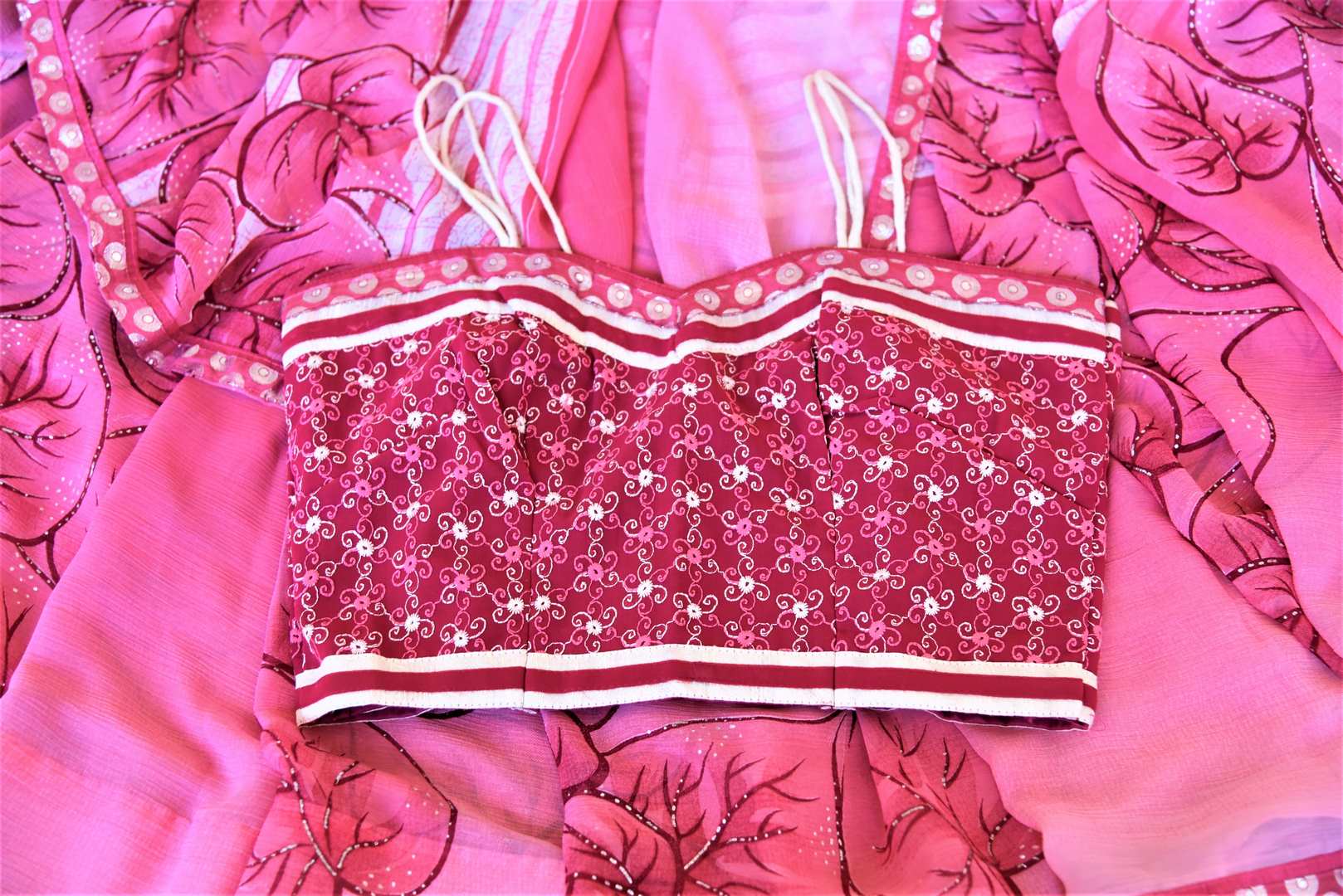 Shop lovely pink leaf print chiffon saree online in USA with strappy blouse. Be the center of attraction at parties and weddings with beautiful georgette sarees, embroidered sarees, printed sarees, Banarasi saris from Pure Elegance Indian fashion store in USA.-details