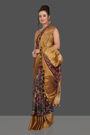 Buy gorgeous black printed Patola tussar saree online in USA with golden border. Shop for weddings and special occasions stunning Banarasi sarees, hand embroidered saris, tussar silk sarees, designer sarees in USA from Pure Elegance Indian clothing store in USA. Shop online now.-side