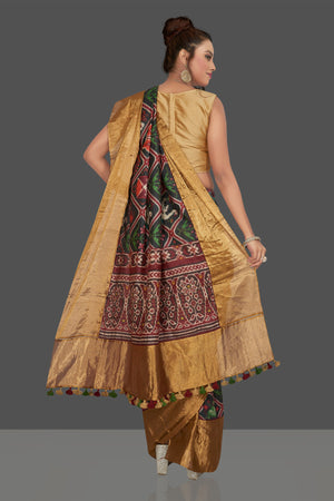 Buy gorgeous black printed Patola tussar saree online in USA with golden border. Shop for weddings and special occasions stunning Banarasi sarees, hand embroidered saris, tussar silk sarees, designer sarees in USA from Pure Elegance Indian clothing store in USA. Shop online now.-back