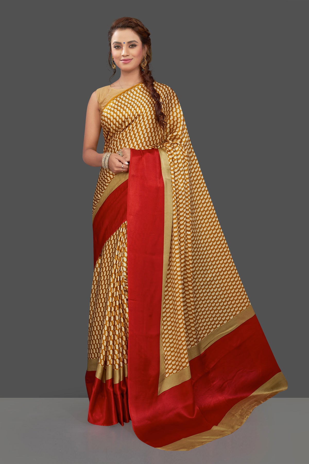 Shop mustard printed crepe silk saree online in USA with solid red border. Elevate your Indian style on special occasions in beautiful designer sarees, crepe silk sarees, georgette saris, printed sarees from Pure Elegance Indian clothing store in USA.-front