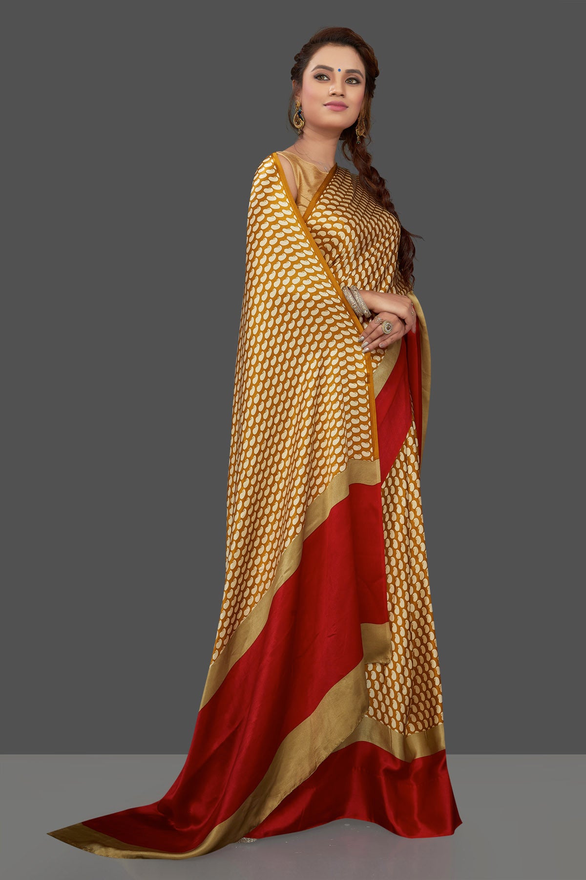 Shop mustard printed crepe silk saree online in USA with solid red border. Elevate your Indian style on special occasions in beautiful designer sarees, crepe silk sarees, georgette saris, printed sarees from Pure Elegance Indian clothing store in USA.-side
