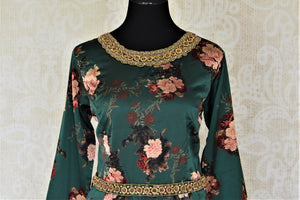 Buy dark green floral hand embroidered silk sharara suit online in USA. Elevate your ethnic style on weddings and festive occasions with stunning designer Anarkali suits, sharara suits, palazzo suits, salwar suits from Pure Elegance Indian fashion boutique in USA.-front