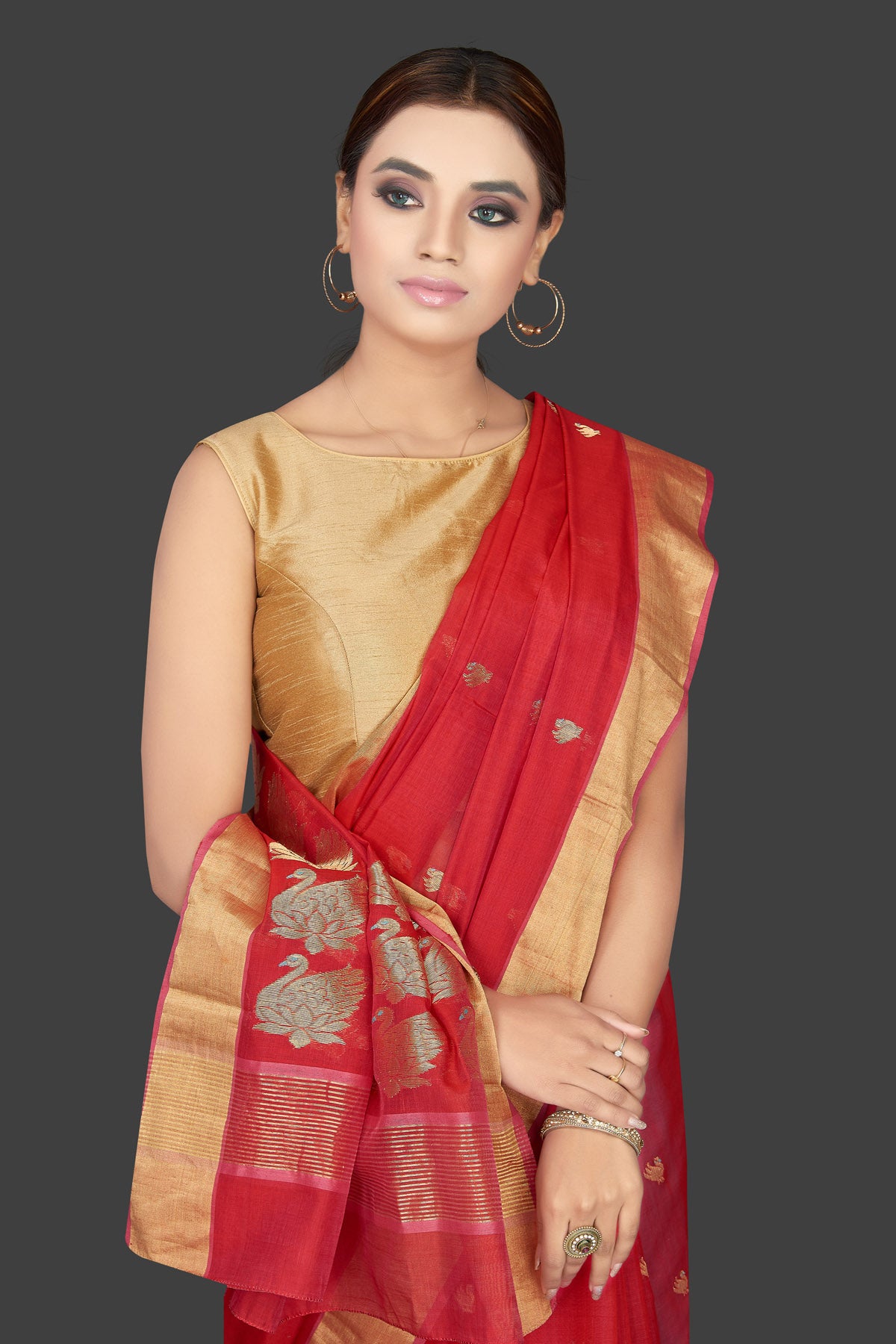 Shop stunning red Chanderi silk saree online in USA with golden zari minakari swan buta and zari border. Flaunt Indian fashion on special occasions in gorgeous chanderi sarees, pure silk sarees, Banarasi sarees, zari work sarees from Pure Elegance Indian fashion boutique in USA.-closeup