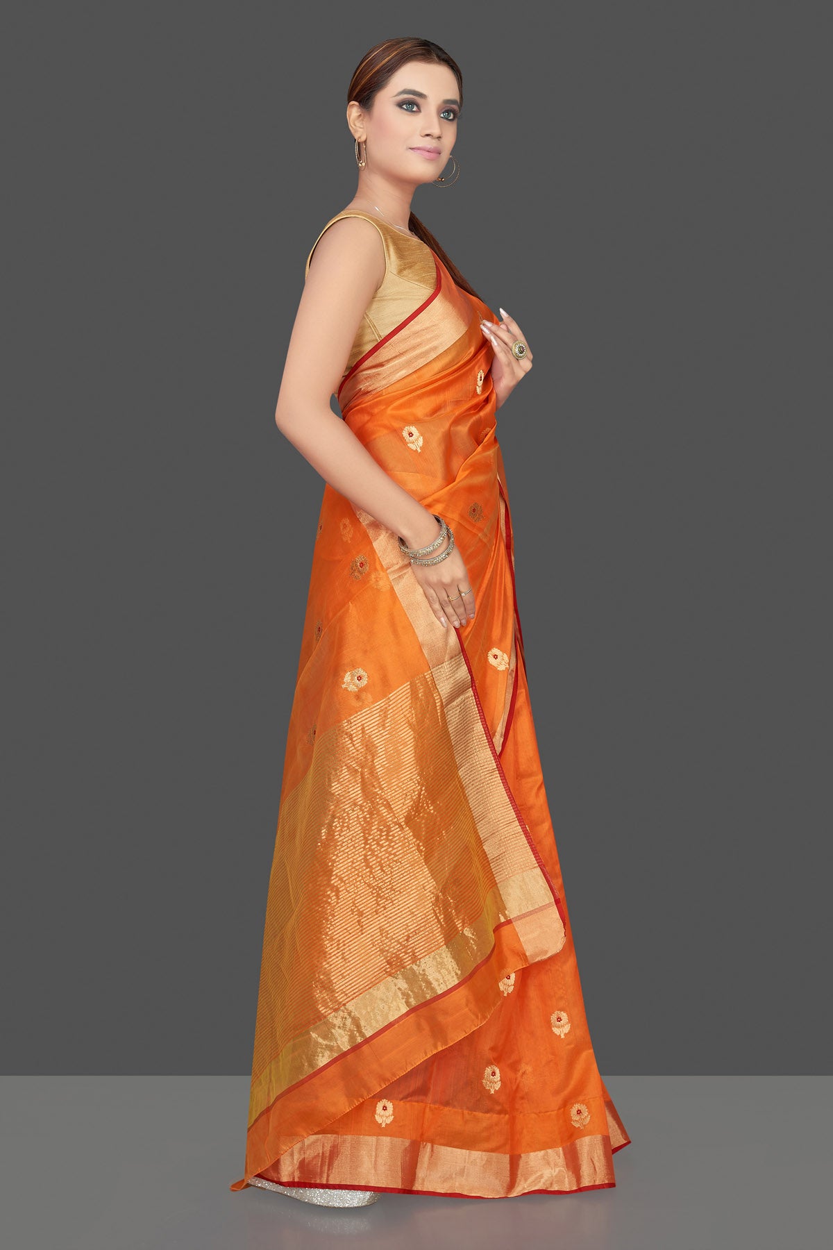 Buy stunning orange color chanderi silk sari online in USA with golden zari minakari flower buta and golden zari border. Flaunt Indian fashion on special occasions in gorgeous chanderi sarees, pure silk sarees, Banarasi sarees, zari work sarees from Pure Elegance Indian fashion boutique in USA.-side