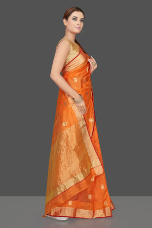Buy stunning orange color chanderi silk sari online in USA with golden zari minakari flower buta and golden zari border. Flaunt Indian fashion on special occasions in gorgeous chanderi sarees, pure silk sarees, Banarasi sarees, zari work sarees from Pure Elegance Indian fashion boutique in USA.-side