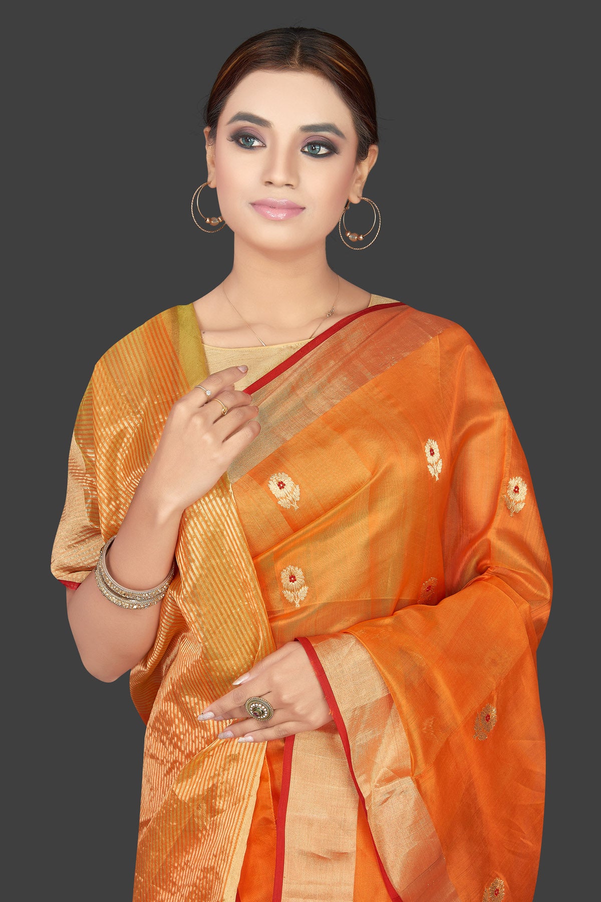 Buy stunning orange color chanderi silk sari online in USA with golden zari minakari flower buta and golden zari border. Flaunt Indian fashion on special occasions in gorgeous chanderi sarees, pure silk sarees, Banarasi sarees, zari work sarees from Pure Elegance Indian fashion boutique in USA.-closeup