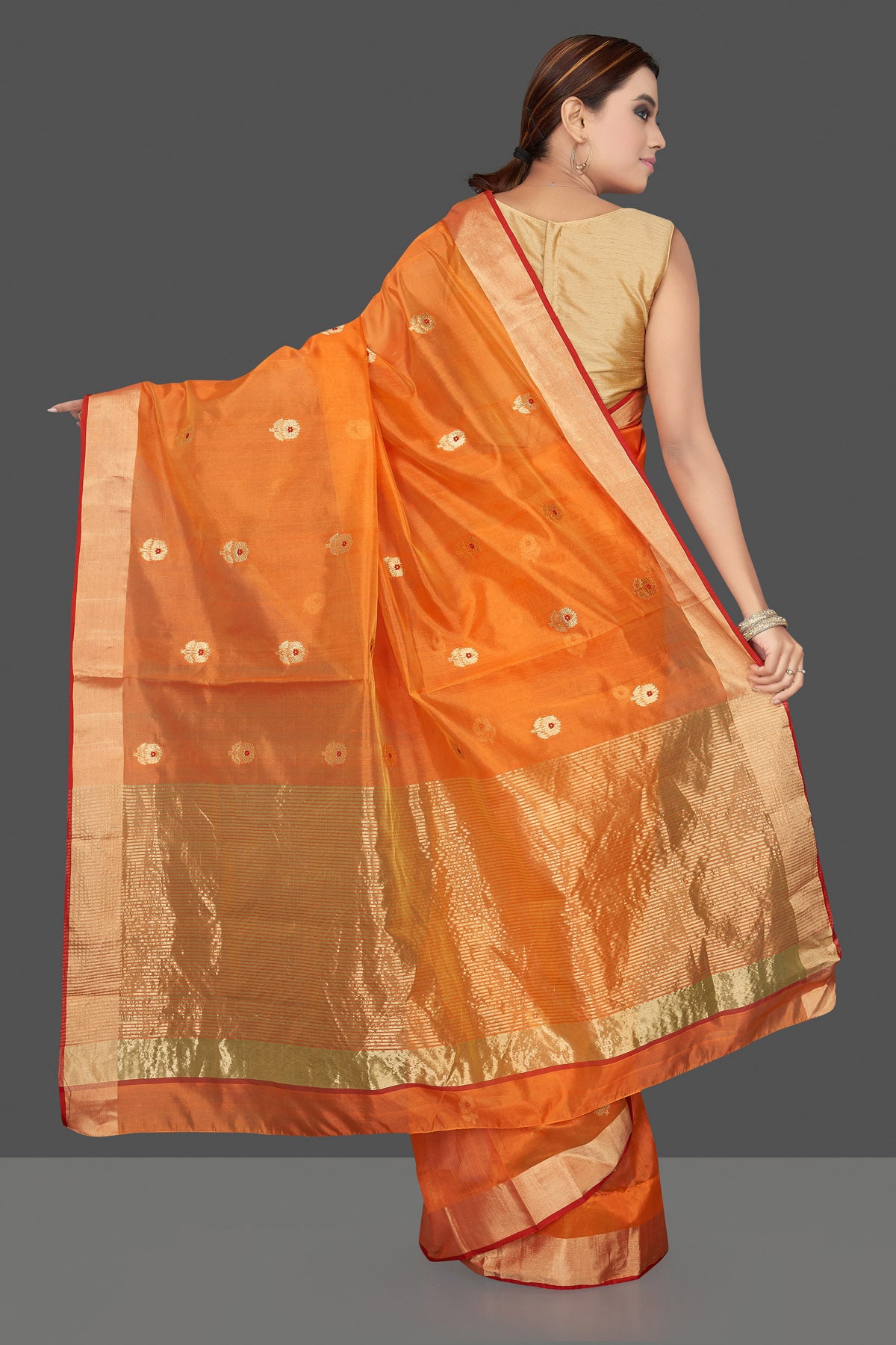 Buy stunning orange color chanderi silk sari online in USA with golden zari minakari flower buta and golden zari border. Flaunt Indian fashion on special occasions in gorgeous chanderi sarees, pure silk sarees, Banarasi sarees, zari work sarees from Pure Elegance Indian fashion boutique in USA.-back