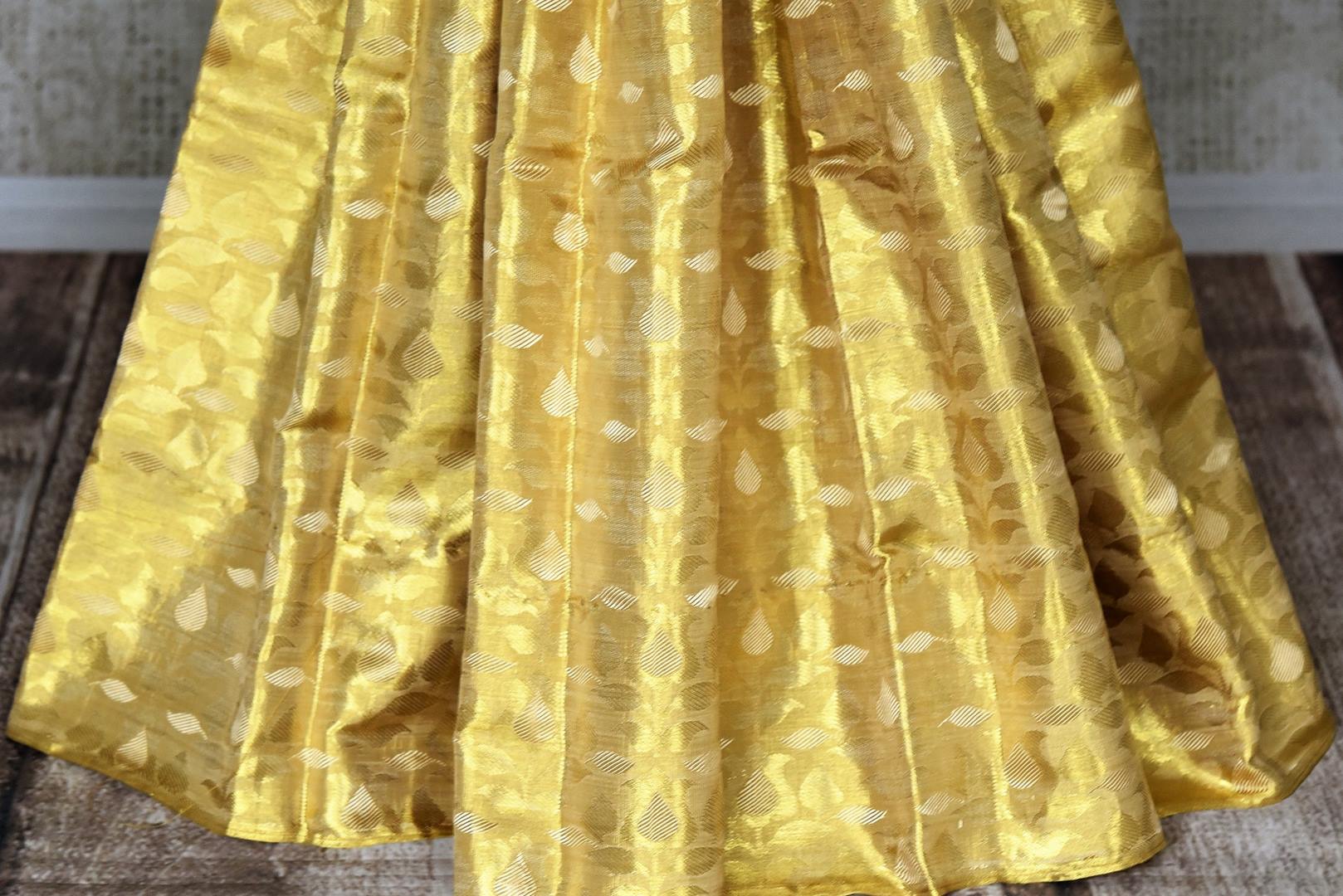 Buy beautiful cream and golden Kanjeevaram sari online in USA with red zari pallu. Look beautiful on special occasions with beautiful Kanjivaram silk sarees, pure silk saris, soft silk sarees, handwoven silk sarees in from Pure Elegance Indian saree store in USA.-pleats
