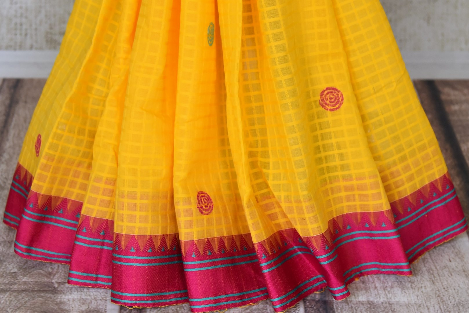 Buy beautiful yellow Bengal cotton saree online in USA with pink border. Look beautiful on special occasions with exquisite Jamdani sarees, cotton sarees, soft silk sarees, handwoven sarees in from Pure Elegance Indian saree store in USA.-pleats