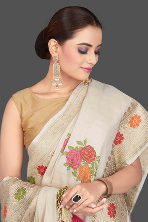 Buy gorgeous cream tussar georgette saree online in USA with floral weave buta and zari border. Look gorgeous on special occasions with exquisite Indian sarees, handwoven sarees, Banarasi sarees, pure silk sarees from Pure Elegance Indian saree store in USA.-closeup