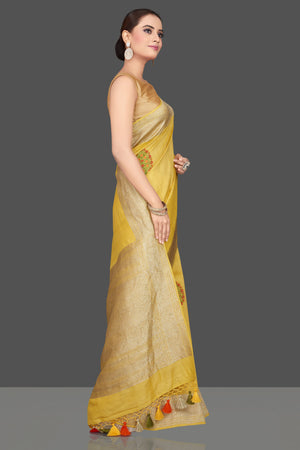 Buy stunning light yellow tussar georgette sari online in USA with tree weave buta and zari border. Look gorgeous on special occasions with exquisite Indian sarees, handwoven sarees, Banarasi sarees, pure silk sarees from Pure Elegance Indian saree store in USA.-side