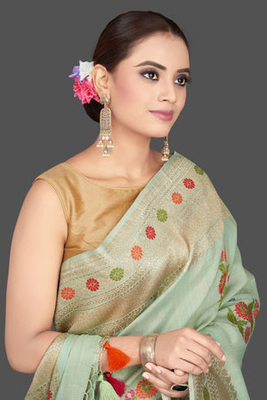 Shop beautiful mint green tussar georgette saree online in USA with floral weave buta and silver zari border. Look gorgeous on special occasions with exquisite Indian sarees, handwoven sarees, Banarasi sarees, pure silk sarees from Pure Elegance Indian saree store in USA.-closeup