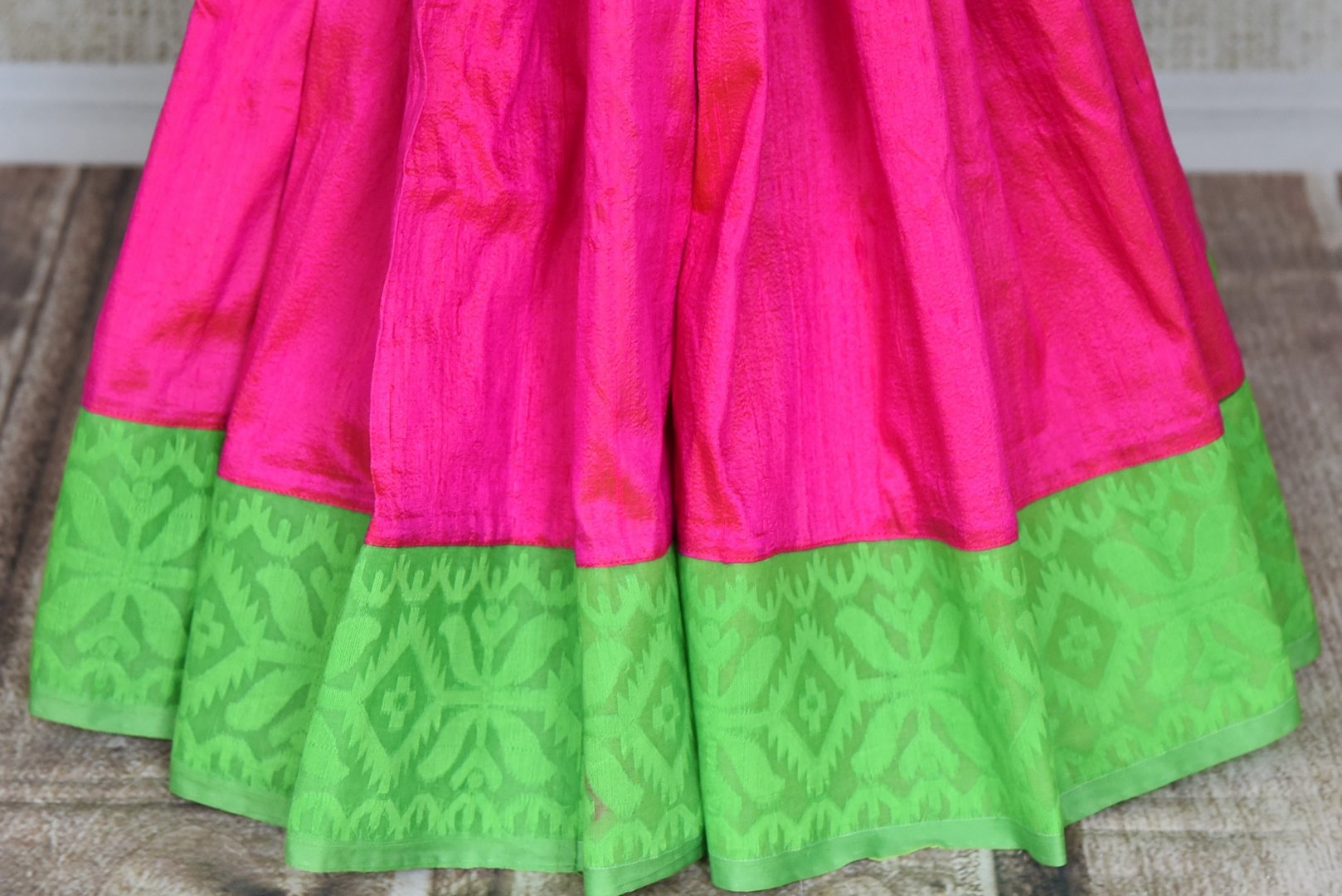 Buy gorgeous pink raw silk sari online in USA with green Jamdani border and saree blouse. Shop beautiful handwoven saris, chanderi sarees, Maheshwari sarees, pure silk sarees, Banarasi sarees online in USA from Pure Elegance Indian fashion store.-pleats