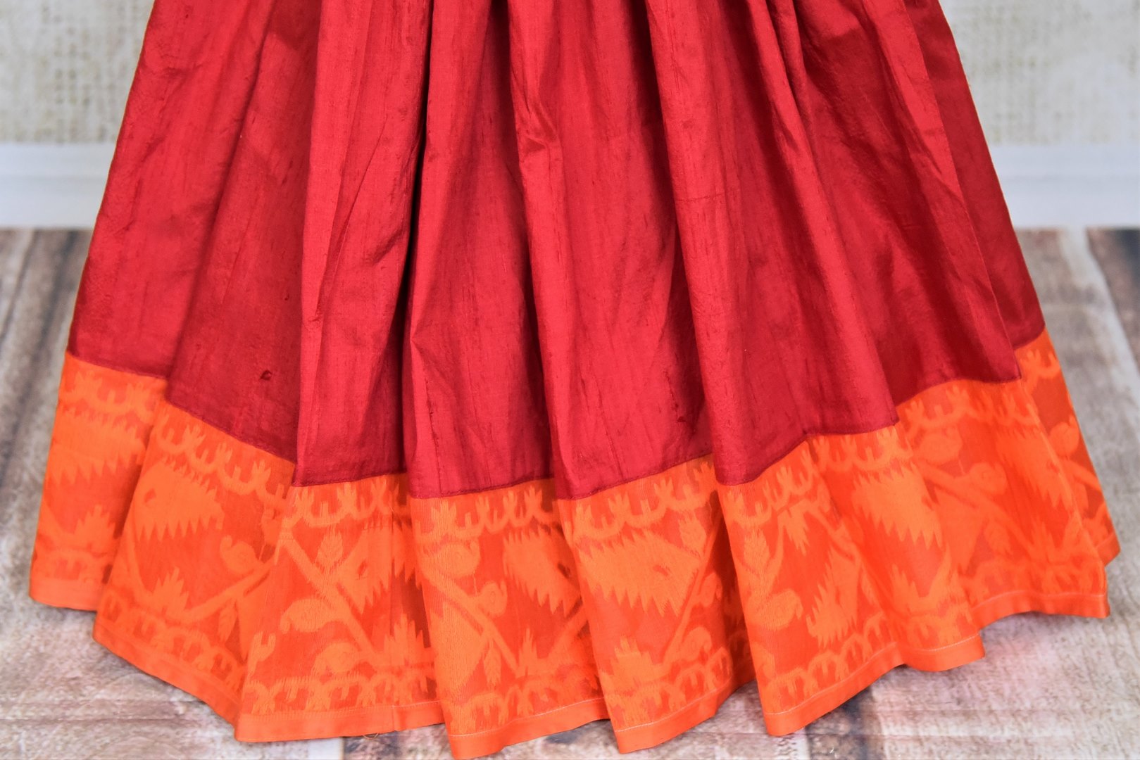 Shop beautiful red raw silk sari online in USA with orange Jamdani border and saree blouse. Shop beautiful handwoven saris, chanderi sarees, Maheshwari sarees, pure silk sarees, Banarasi sarees online in USA from Pure Elegance Indian fashion store.-pleats