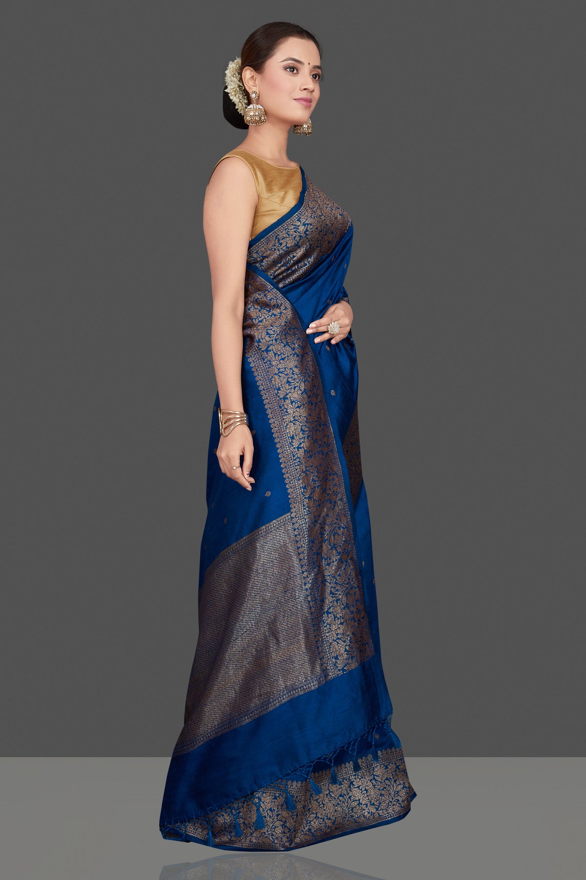 Buy stunning dark blue tussar Banarasi saree online in USA with antique zari buta border. Go for stunning Indian designer sarees, georgette sarees, handwoven saris, embroidered sarees for festive occasions and weddings from Pure Elegance Indian clothing store in USA.-side