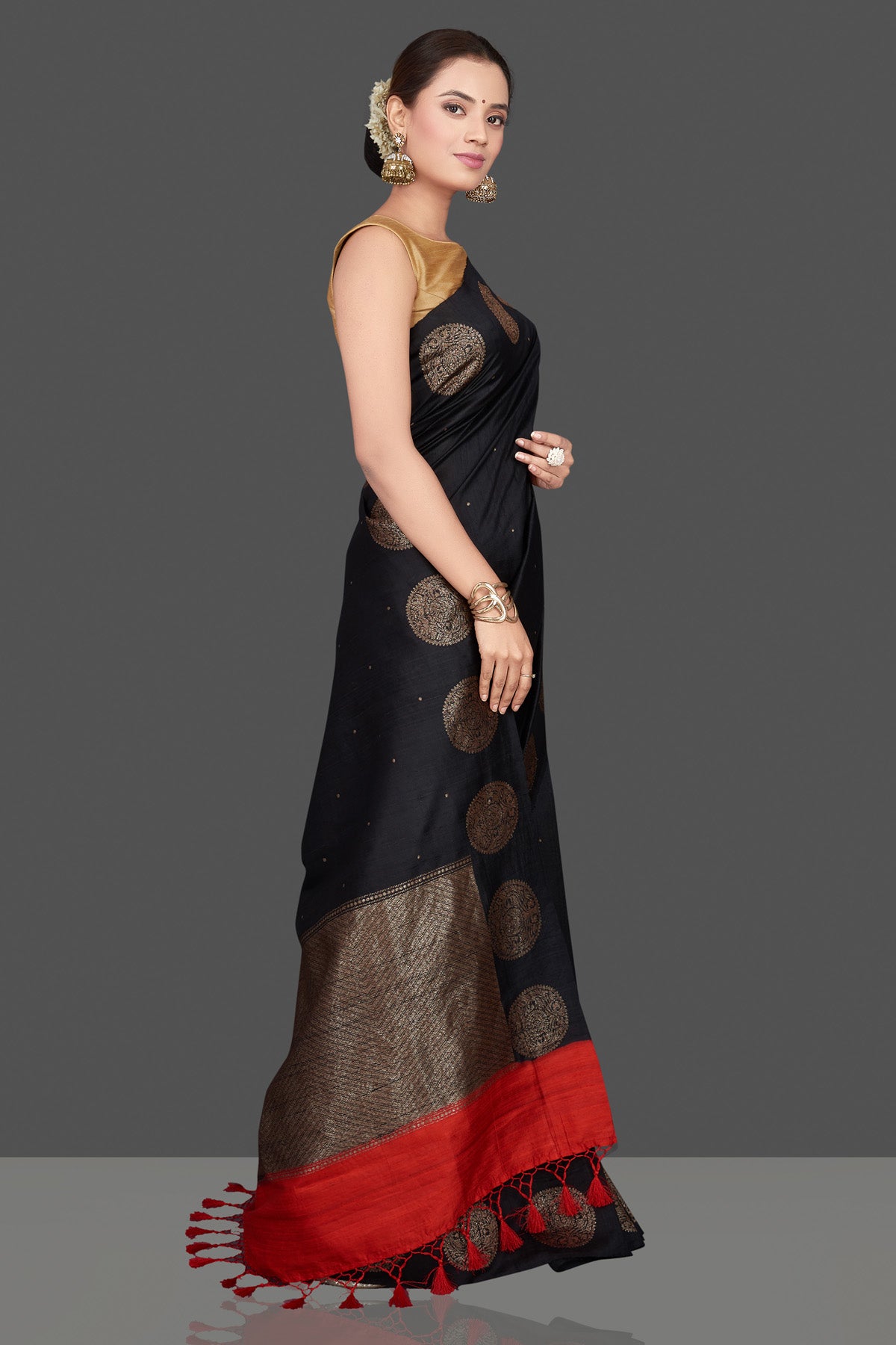 Buy ravishing black tussar Benarasi saree online in USA with antique zari buta border. Go for stunning Indian designer sarees, georgette sarees, handwoven saris, embroidered sarees for festive occasions and weddings from Pure Elegance Indian clothing store in USA.-side