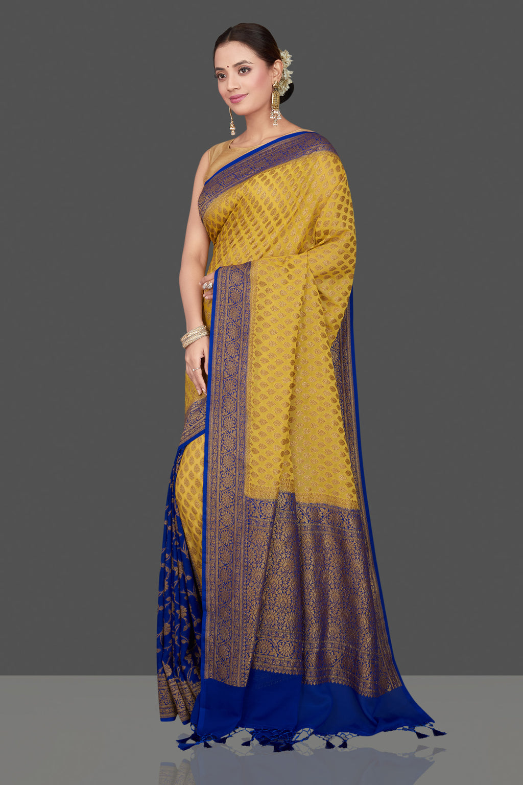 Buy stunning yellow georgette Banarasi saree online in USA with blue zari border. Get ready for festive occasions and weddings in tasteful designer sarees, Banarasi sarees, handwoven sarees from Pure Elegance Indian clothing store in USA.-full view