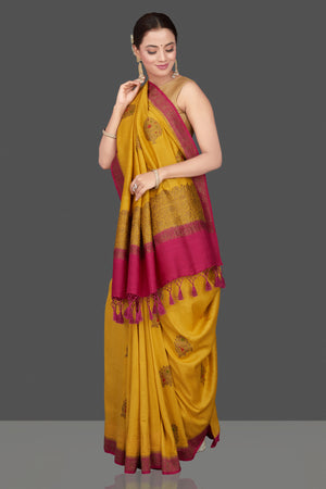 Shop stunning yellow Muga Banarasi saree online in USA with pink antique zari border. Get ready for festive occasions and weddings in tasteful designer sarees, Banarasi sarees, handwoven sarees from Pure Elegance Indian clothing store in USA.-pallu