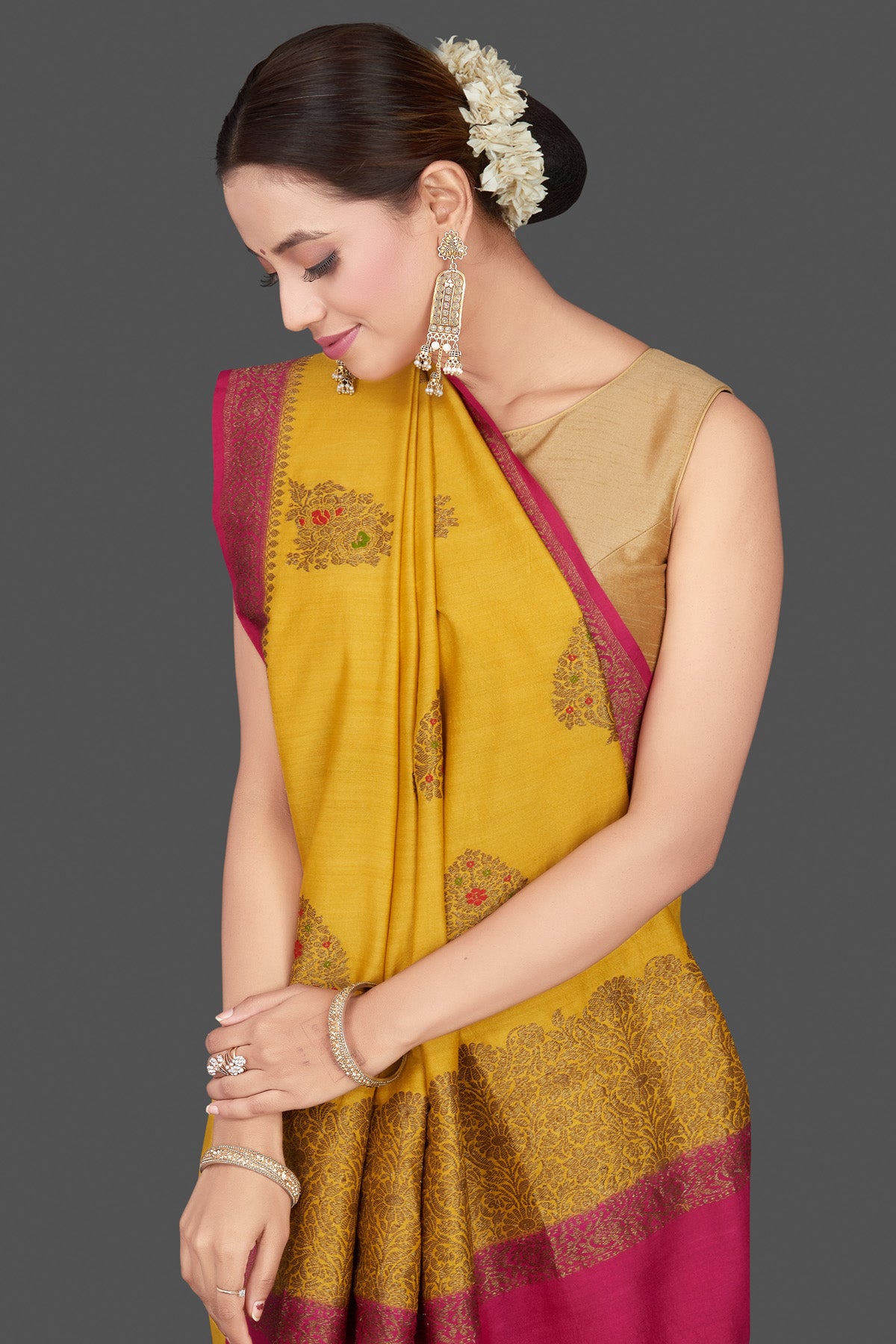 Shop stunning yellow Muga Banarasi saree online in USA with pink antique zari border. Get ready for festive occasions and weddings in tasteful designer sarees, Banarasi sarees, handwoven sarees from Pure Elegance Indian clothing store in USA.-closeup