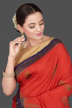 Shop beautiful red Muga Banarasi saree online in USA with blue antique zari border. Get ready for festive occasions and weddings in tasteful designer sarees, Banarasi sarees, handwoven sarees from Pure Elegance Indian clothing store in USA.-closeup