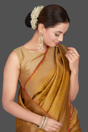Buy gorgeous mustard tussar Banarasi sari online in USA with golden zari work. Get ready for festive occasions and weddings in tasteful designer saris, Banarasi sarees, handwoven sarees from Pure Elegance Indian clothing store in USA.-closeup