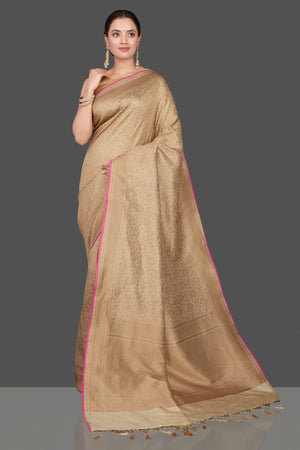 Buy beautiful beige tussar Banarasi saree online in USA with golden zari work. Get ready for festive occasions and weddings in tasteful designer saris, Banarasi sarees, handwoven sarees from Pure Elegance Indian clothing store in USA.-front