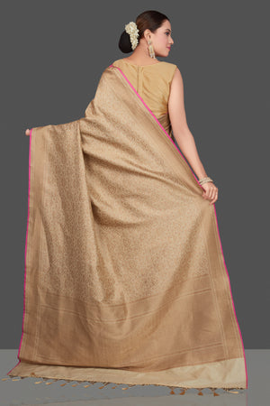 Buy beautiful beige tussar Banarasi saree online in USA with golden zari work. Get ready for festive occasions and weddings in tasteful designer saris, Banarasi sarees, handwoven sarees from Pure Elegance Indian clothing store in USA.-back