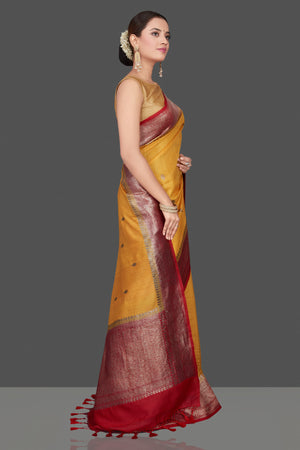 Shop beautiful yellow tussar Banarasi saree online in USA with red zari border. Get ready for festive occasions and weddings in tasteful designer saris, Banarasi sarees, handwoven sarees from Pure Elegance Indian clothing store in USA.-side