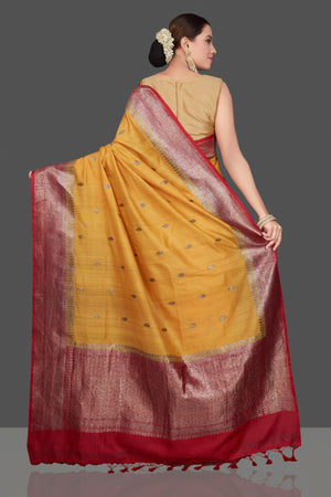Shop beautiful yellow tussar Banarasi saree online in USA with red zari border. Get ready for festive occasions and weddings in tasteful designer saris, Banarasi sarees, handwoven sarees from Pure Elegance Indian clothing store in USA.-back