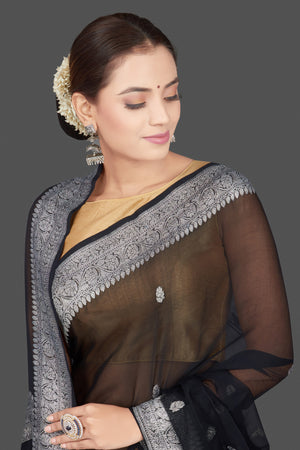 Buy black chiffon georgette saree online in USA with silver zari border. Go for stunning Indian designer sarees, georgette sarees, handwoven saris, embroidered sarees for festive occasions and weddings from Pure Elegance Indian clothing store in USA.-closeup