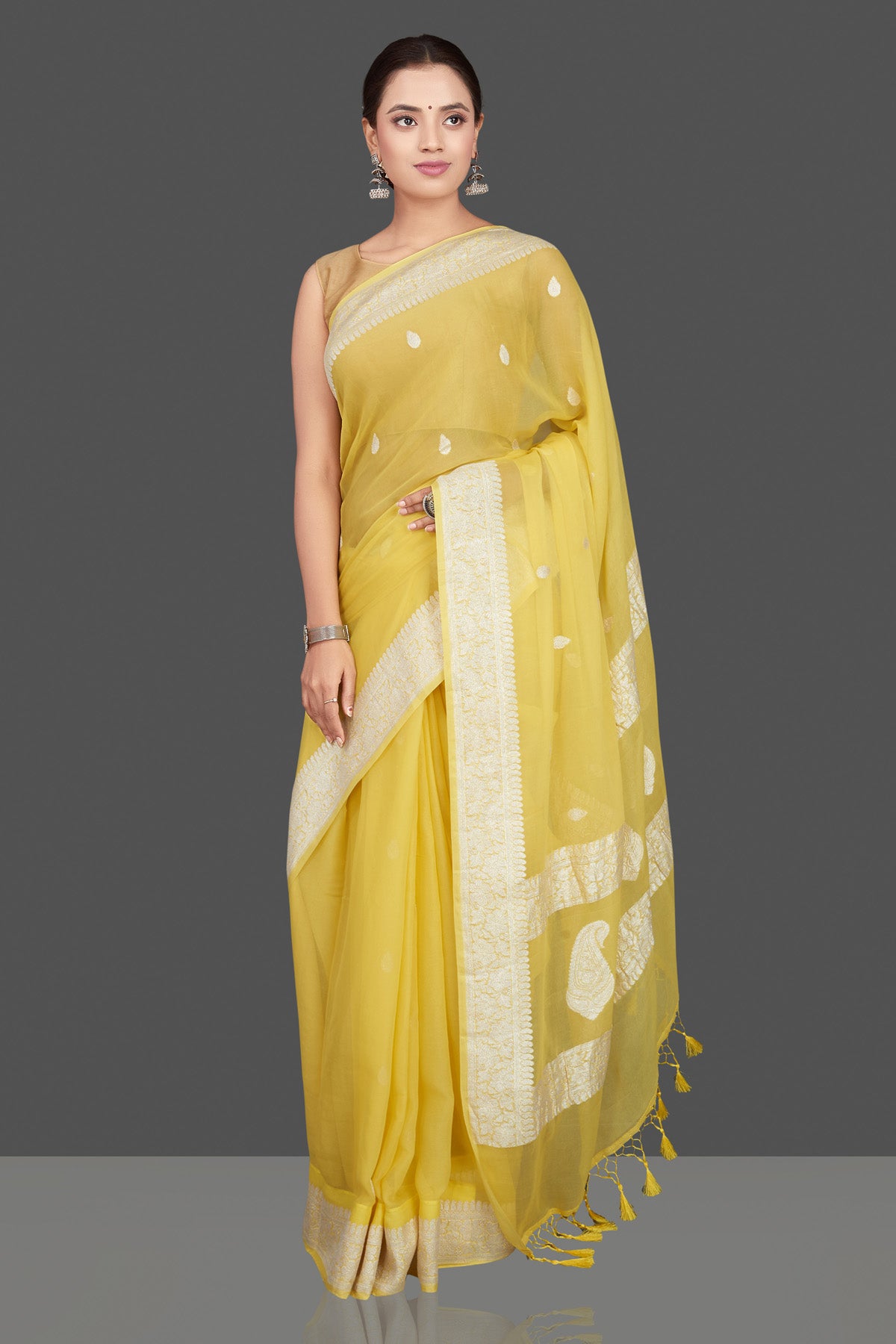 Shop charming yellow color chiffon georgette saree online in USA with silver zari border. Go for stunning Indian designer sarees, georgette sarees, handwoven saris, embroidered sarees for festive occasions and weddings from Pure Elegance Indian clothing store in USA.-full view