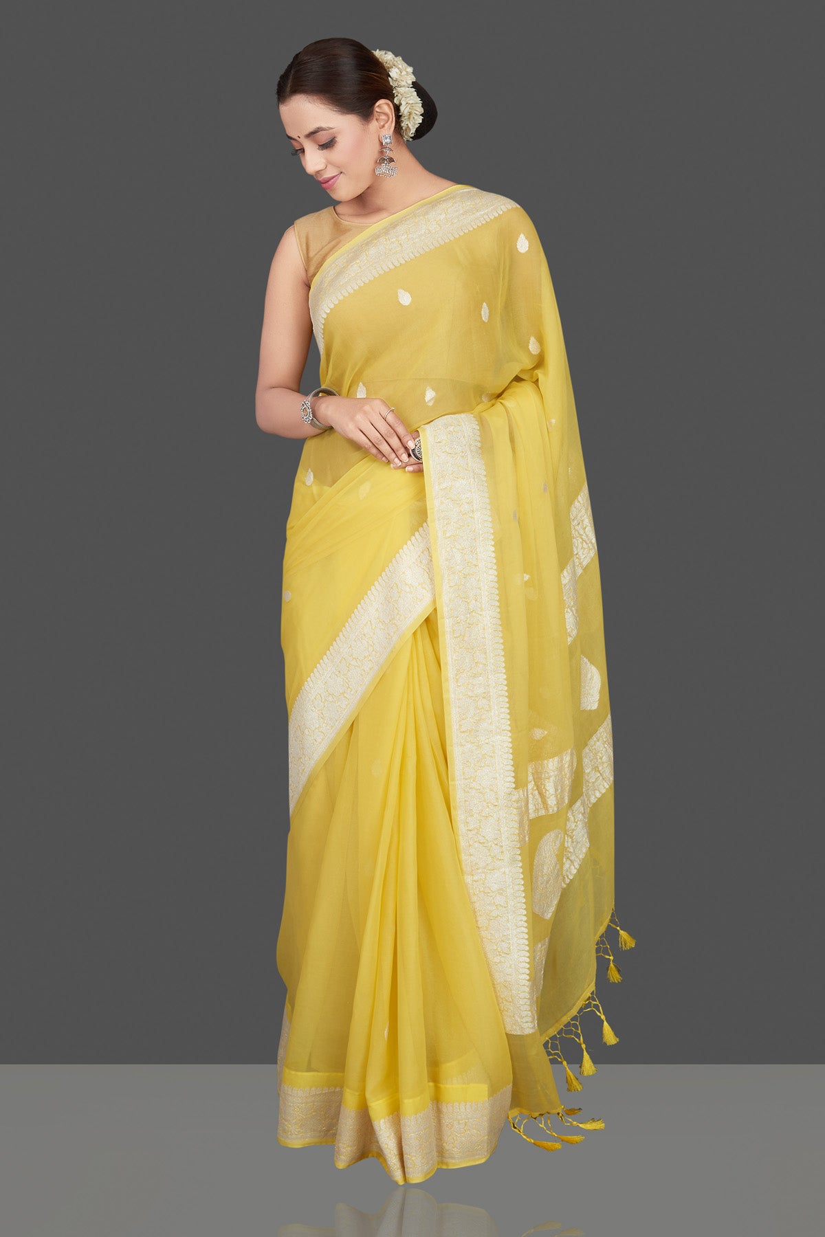 Shop charming yellow color chiffon georgette saree online in USA with silver zari border. Go for stunning Indian designer sarees, georgette sarees, handwoven saris, embroidered sarees for festive occasions and weddings from Pure Elegance Indian clothing store in USA.-side