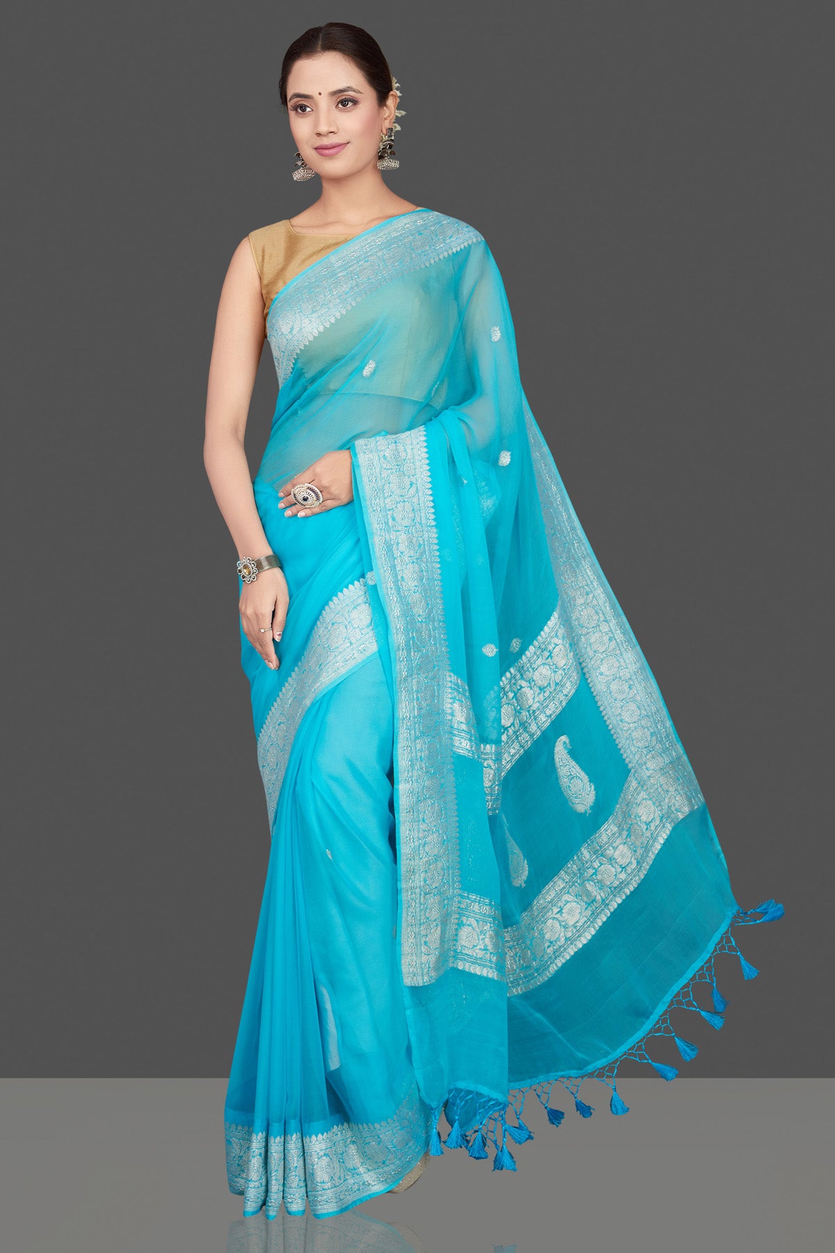 Buy beautiful sky blue chiffon georgette sari online in USA with silver zari border. Go for stunning Indian designer sarees, georgette sarees, handwoven saris, embroidered sarees for festive occasions and weddings from Pure Elegance Indian clothing store in USA.-full view