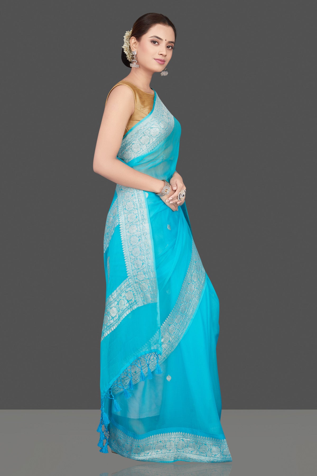 Buy beautiful sky blue chiffon georgette sari online in USA with silver zari border. Go for stunning Indian designer sarees, georgette sarees, handwoven saris, embroidered sarees for festive occasions and weddings from Pure Elegance Indian clothing store in USA.-side