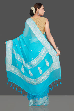 Buy beautiful sky blue chiffon georgette sari online in USA with silver zari border. Go for stunning Indian designer sarees, georgette sarees, handwoven saris, embroidered sarees for festive occasions and weddings from Pure Elegance Indian clothing store in USA.-back