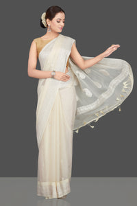 Shop cream georgette chiffon sari online in USA with silver zari border. Go for stunning Indian designer sarees, georgette sarees, handwoven sarees, embroidered sarees for festive occasions and weddings from Pure Elegance Indian clothing store in USA.-full view