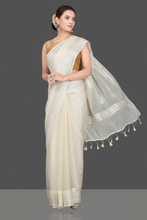 Shop cream georgette chiffon sari online in USA with silver zari border. Go for stunning Indian designer sarees, georgette sarees, handwoven sarees, embroidered sarees for festive occasions and weddings from Pure Elegance Indian clothing store in USA.-front