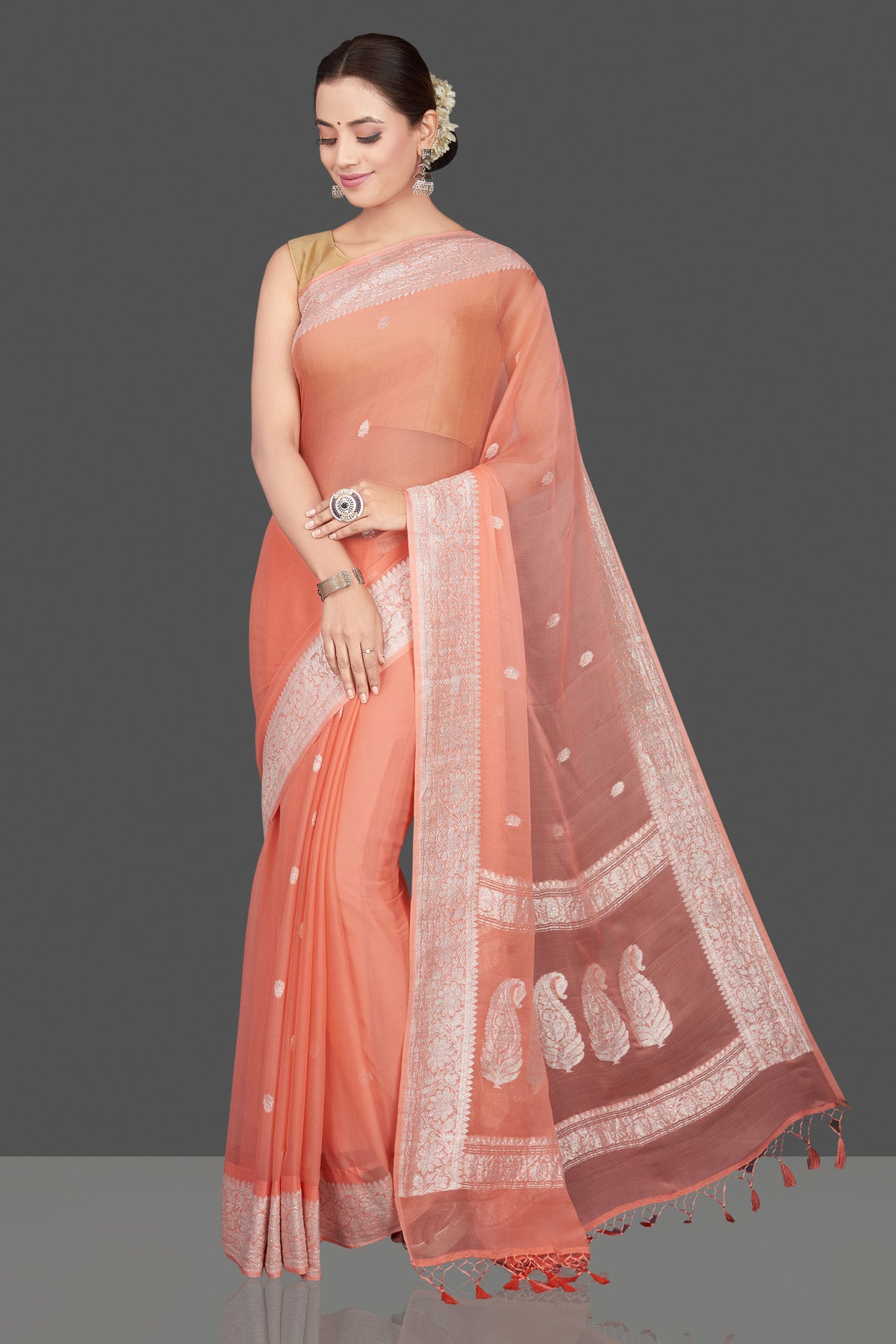 Buy stunning peach color georgette chiffon saree online in USA with silver zari border. Go for stunning Indian designer sarees, georgette sarees, handwoven sarees, embroidered sarees for festive occasions and weddings from Pure Elegance Indian clothing store in USA.-full view