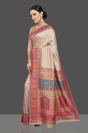 Shop beautiful cream tussar silk sari online in USA with kani embroidery. Look beautiful on weddings and special occasions in stunning Kanchipuram saris, pure silk sarees, handwoven saris from Pure Elegance Indian fashion store in USA.-pallu