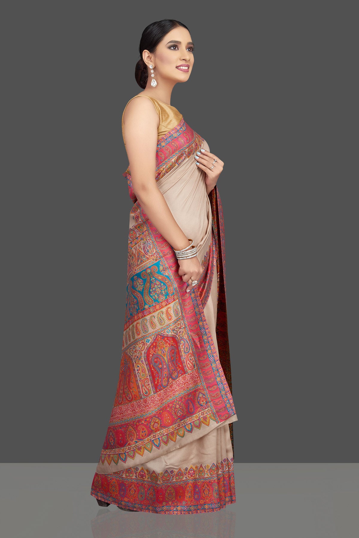 Shop beautiful cream tussar silk sari online in USA with kani embroidery. Look beautiful on weddings and special occasions in stunning Kanchipuram saris, pure silk sarees, handwoven saris from Pure Elegance Indian fashion store in USA.-side