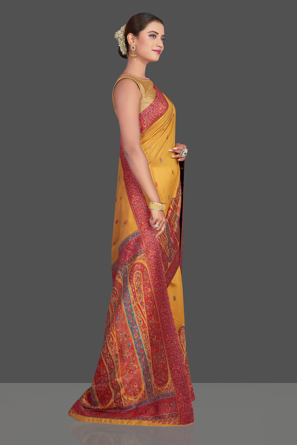 Shop beautiful mustard yellow Kani embroidery tussar silk sari online in USA. Make your presence felt on special occasions in beautiful embroidered sarees, handwoven sarees, pure silk saris, tussar sarees from Pure Elegance Indian saree store in USA.-side