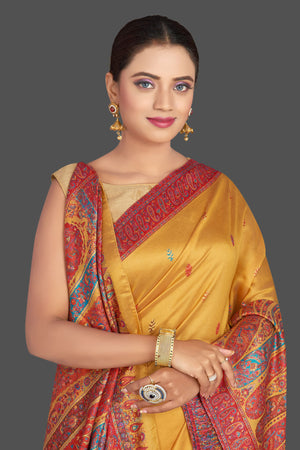 Shop beautiful mustard yellow Kani embroidery tussar silk sari online in USA. Make your presence felt on special occasions in beautiful embroidered sarees, handwoven sarees, pure silk saris, tussar sarees from Pure Elegance Indian saree store in USA.-closeup