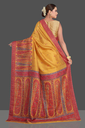Shop beautiful mustard yellow Kani embroidery tussar silk sari online in USA. Make your presence felt on special occasions in beautiful embroidered sarees, handwoven sarees, pure silk saris, tussar sarees from Pure Elegance Indian saree store in USA.-back