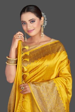 Shop gorgeous yellow tussar Banarasi saree online in USA with antique zari border. Look your best on special occasions with stunning Banarasi saris, pure silk saris, tussar sarees, handwoven sarees from Pure Elegance Indian saree store in USA.-closeup