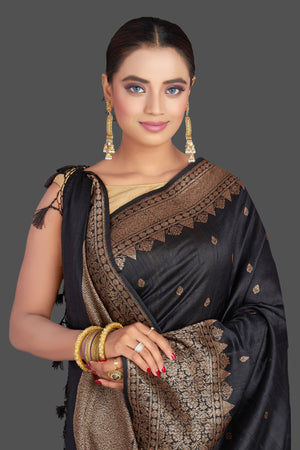 Shop black tussar Banarasi sari online in USA with antique zari border. Look your best on special occasions with stunning Banarasi saris, pure silk sarees, tussar sarees, handwoven sarees from Pure Elegance Indian saree store in USA.-closeup