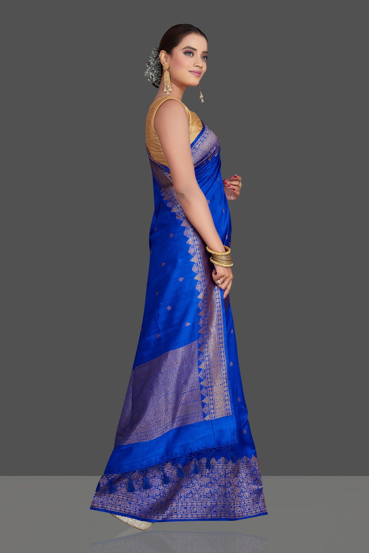 Buy stunning bright blue tussar Banarasi saree online in USA with antique zari border. Look your best on special occasions with stunning Banarasi saris, pure silk sarees, tussar sarees, handwoven sarees from Pure Elegance Indian saree store in USA.-side