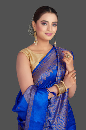 Buy stunning bright blue tussar Banarasi saree online in USA with antique zari border. Look your best on special occasions with stunning Banarasi saris, pure silk sarees, tussar sarees, handwoven sarees from Pure Elegance Indian saree store in USA.-closeup