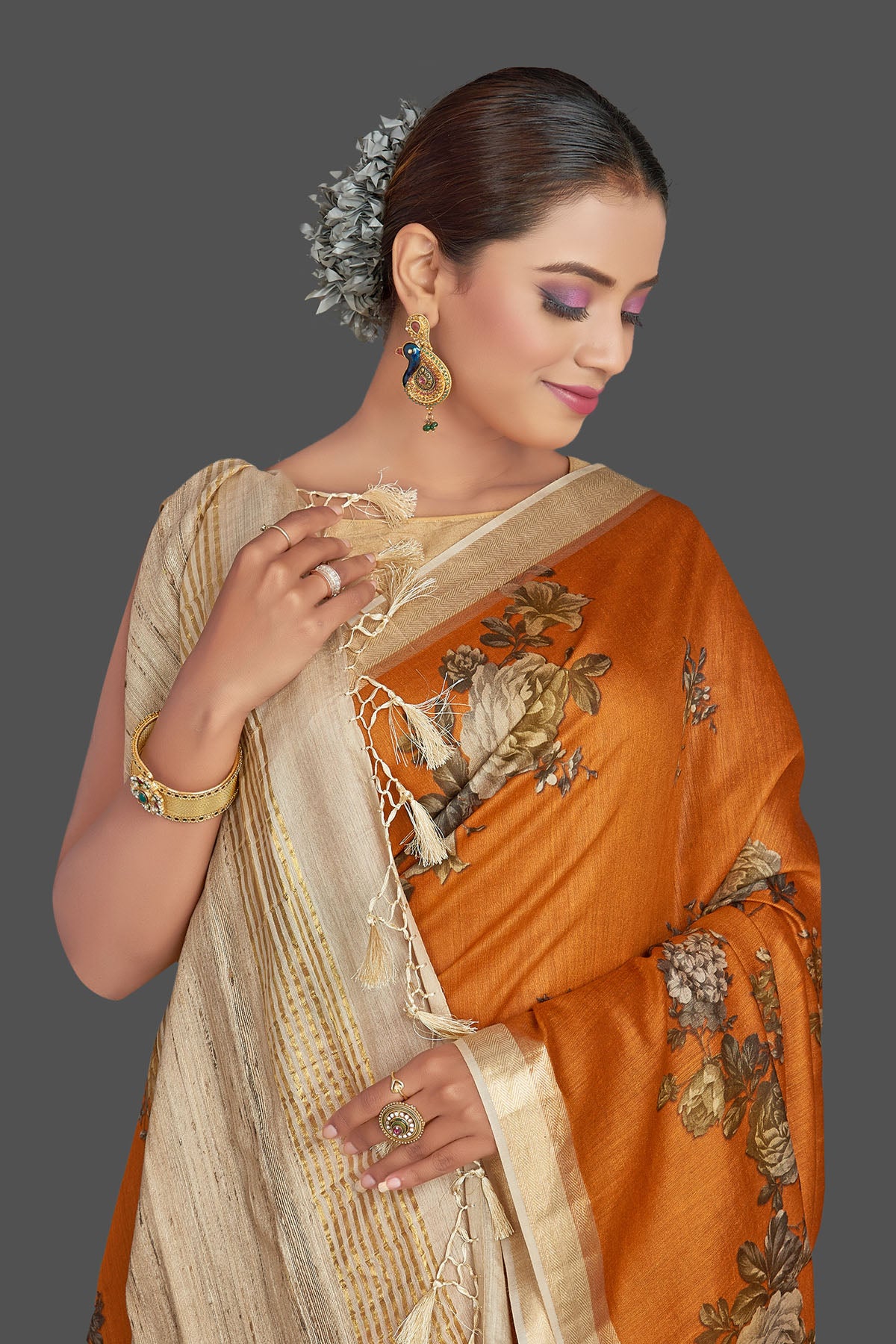 Buy stunning dark orange floral print tussar Banarasi saree online in USA with beige pallu. Look your best on special occasions with stunning Banarasi saris, pure silk saris, tussar sarees, handwoven sarees from Pure Elegance Indian saree store in USA.-closeup